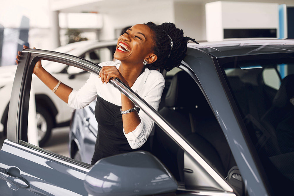 woman excited looking at new vehicle
