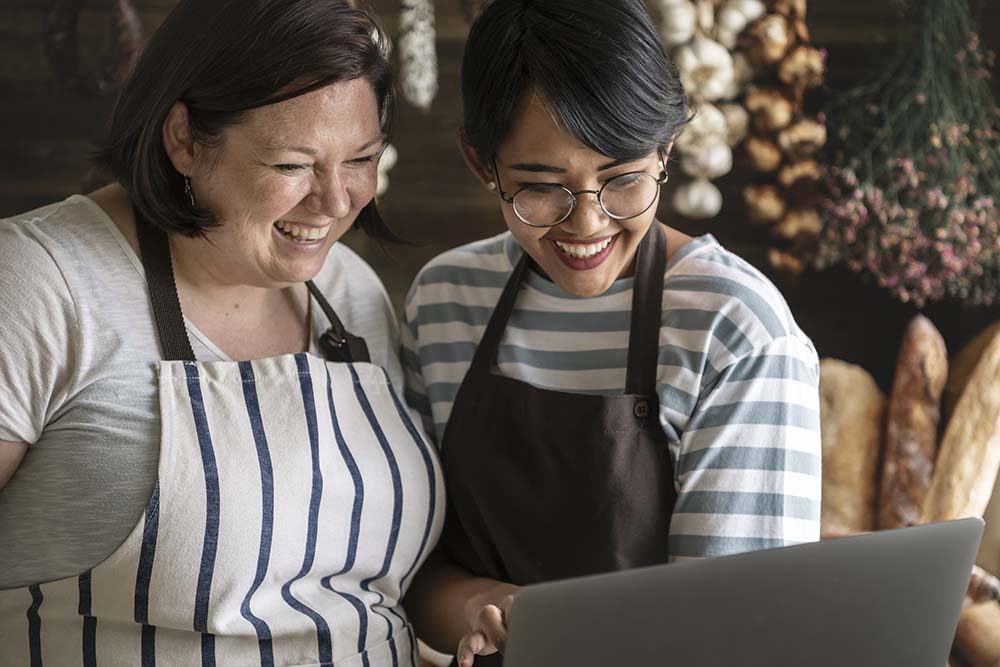 business owners looking at laptop together