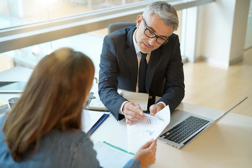 businessman reviewing documents with client