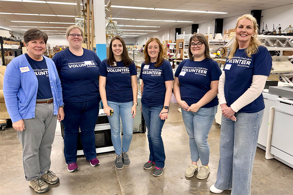 A group of DCCU employees pose at the Habitat for Humanity ReStore in Harrisonburg, Virginia, during a volunteer shift. 