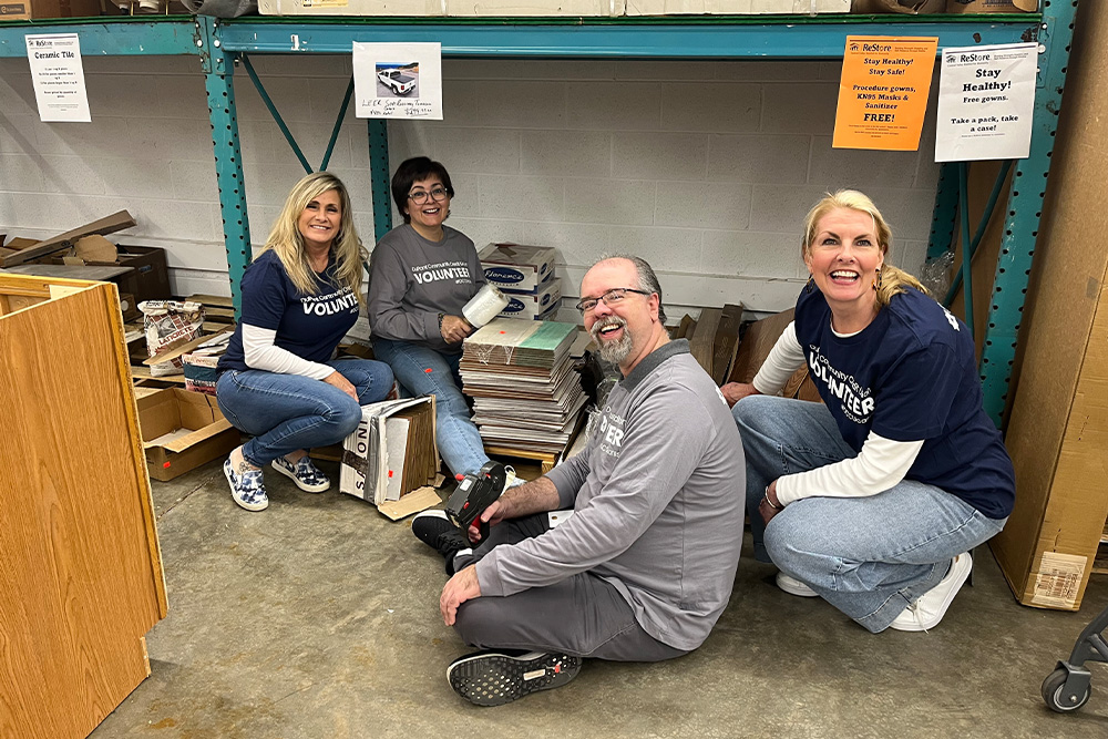 A group of DCCU employees pose for the camera during a volunteer shift at the Habitat for Humanity ReStore in Waynesboro, Virginia. 