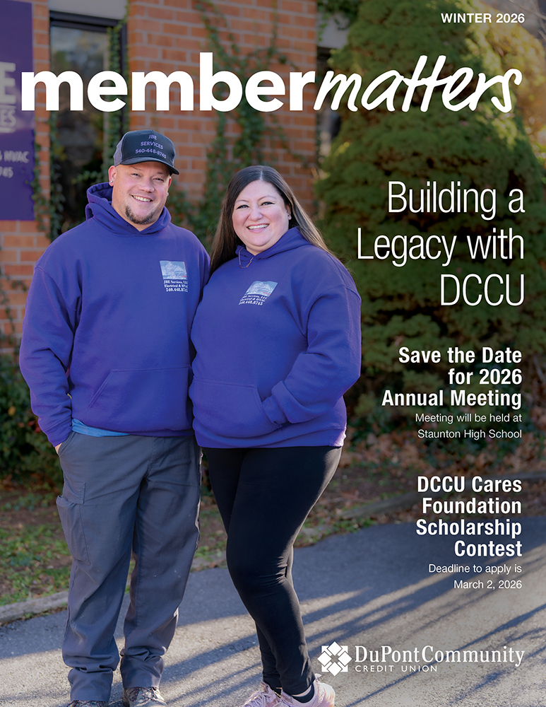 A man and woman stand together, smiling. 