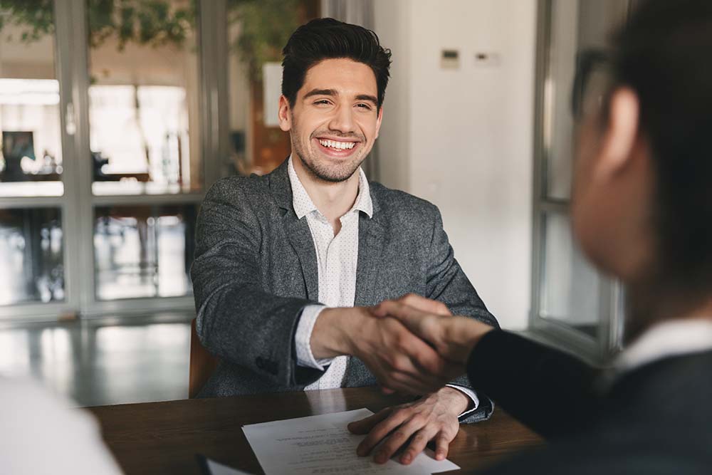 young man shaking hands at business interview