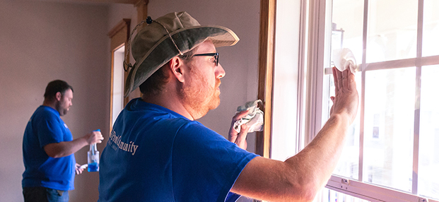 DCCU employees volunteering and cleaning windows