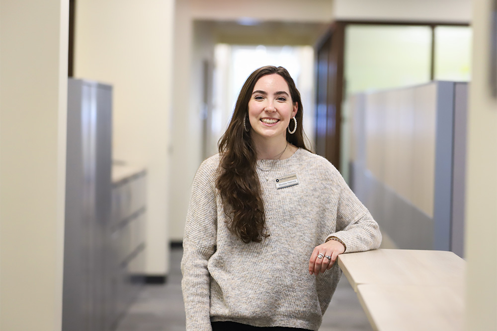 DCCU mentee, Maddie, stands in front of the camera, smiling