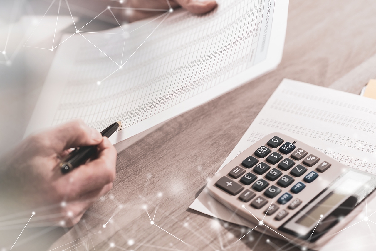 Hands of accountant checking financial document; multiple exposure