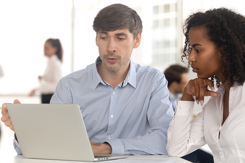 Financial advisor reviewing laptop with client