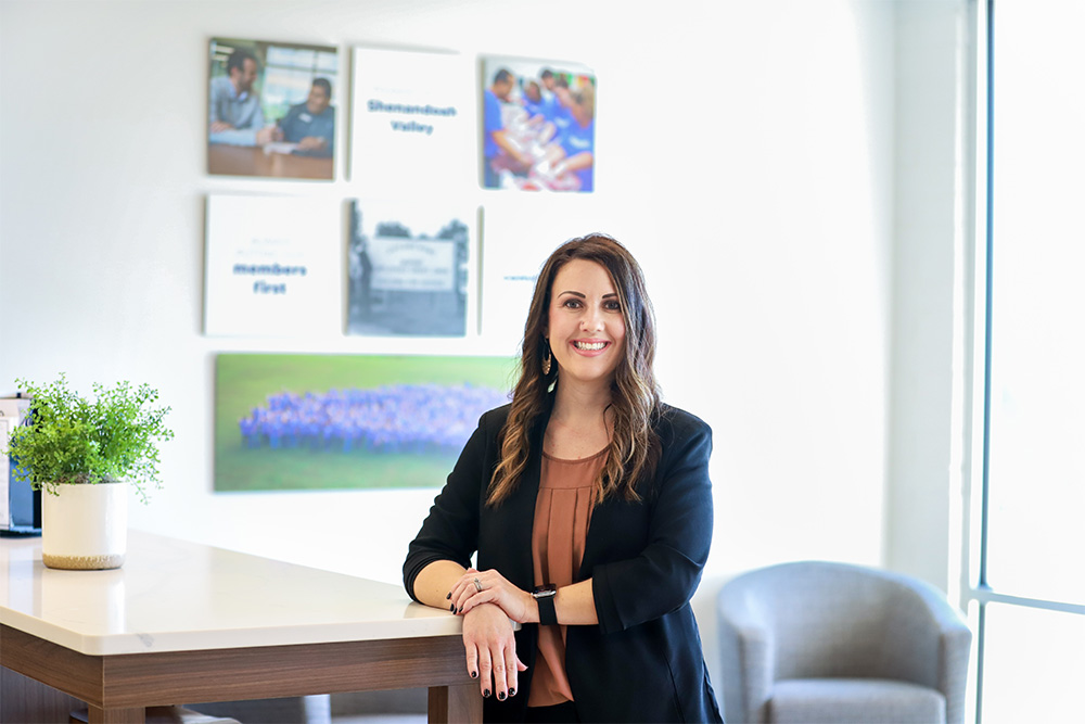 DCCU Retail Branch Manager, Summer, smiles for the camera in the lobby of our Windward Pointe Member Center.