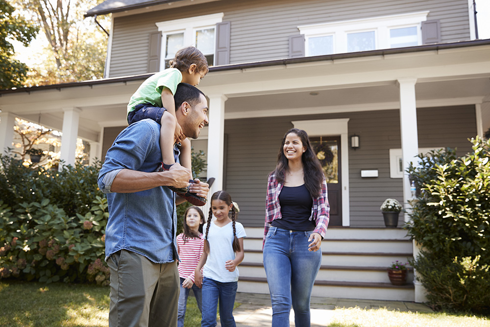 family outside in front of house