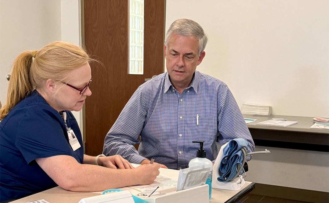 DCCU employee, Josh, received a health screening from a nurse at Augusta Health