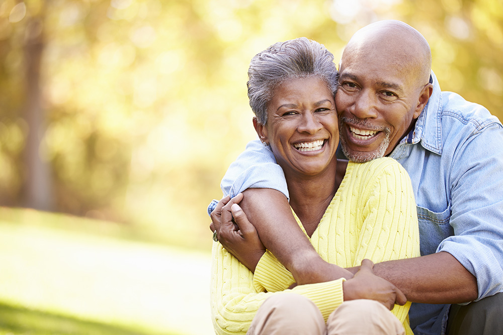 Elderly couple smiling outside