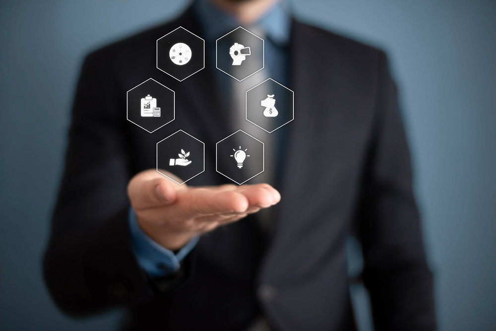 A person in a suit holding a hand out with icons superimposed on the graphic