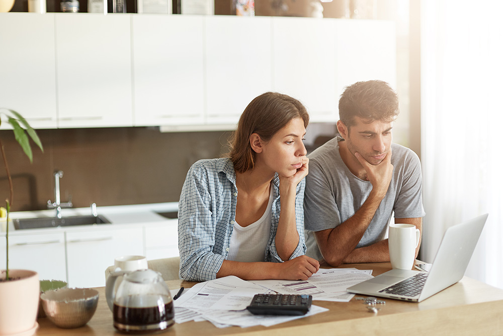 couple looking at laptop concerned