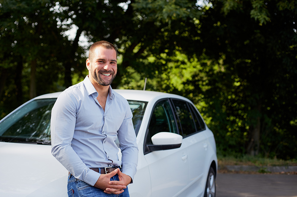 man leaning on car outside