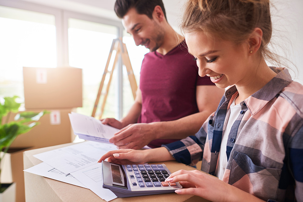 Man and woman with calculator looking at paperwork