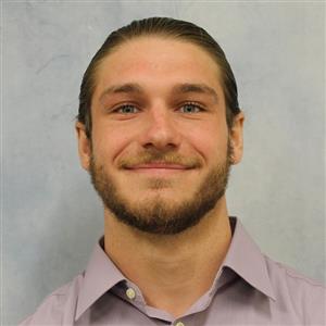 DCCU Seasonal Clerk, Noah, smiles for the camera in his headshot. 