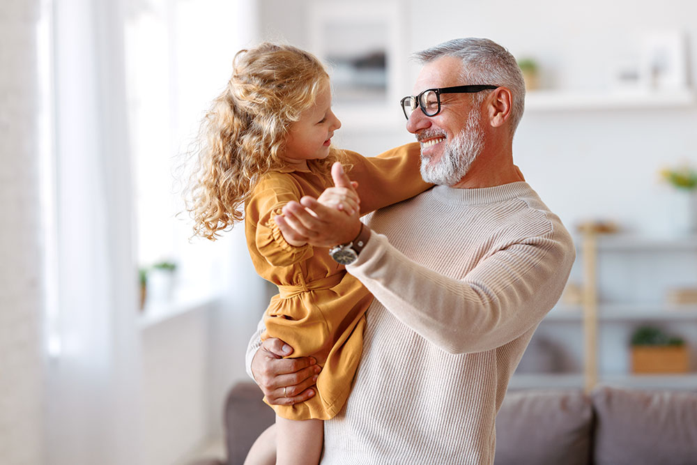 Grandfather dancing with grandaughter