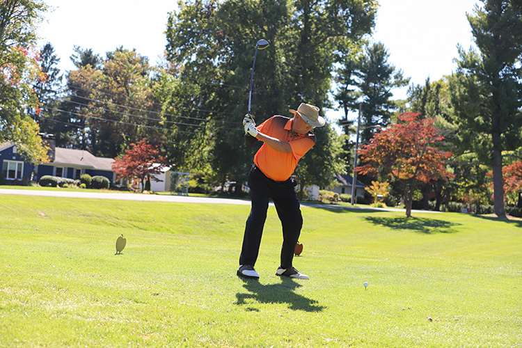 2024 DCCU Cares Foundation Golf Tournament participant swinging at ball