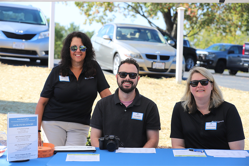 DCCU employees, Cindy, Chris, and Cheryl (l-r) smile for the camera during the DCCU Cares Foundation golf tournament in September 2025.