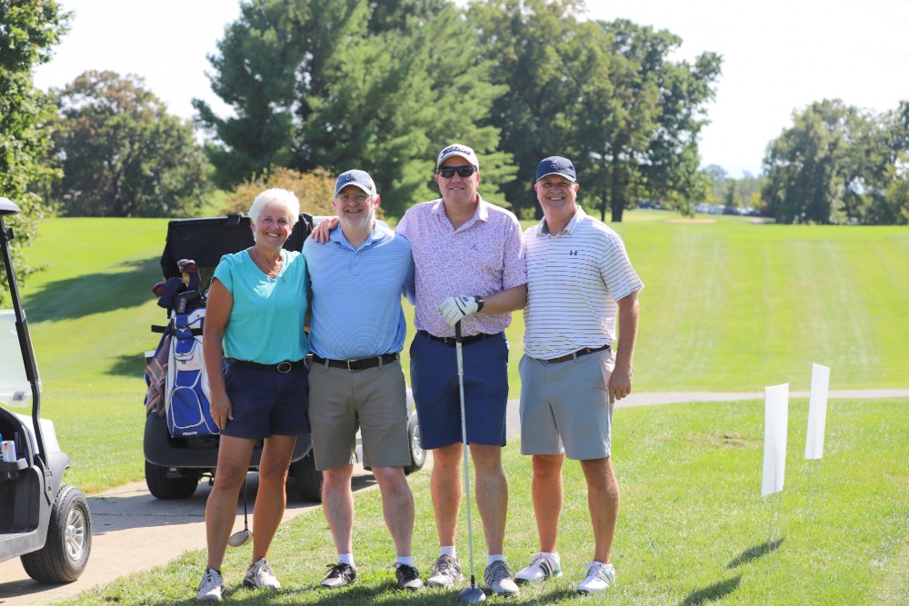A group of golfers pose for the camera