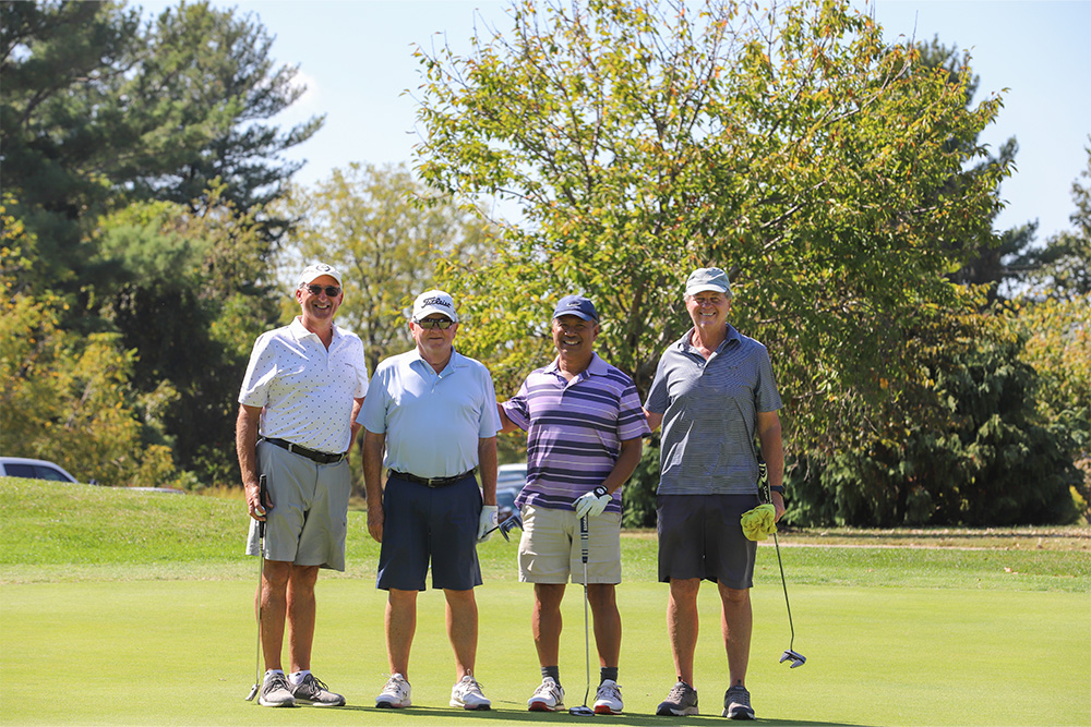 A group of golfers pose for the camera during the 2025 DCCU Cares Foundation charity golf tournament.