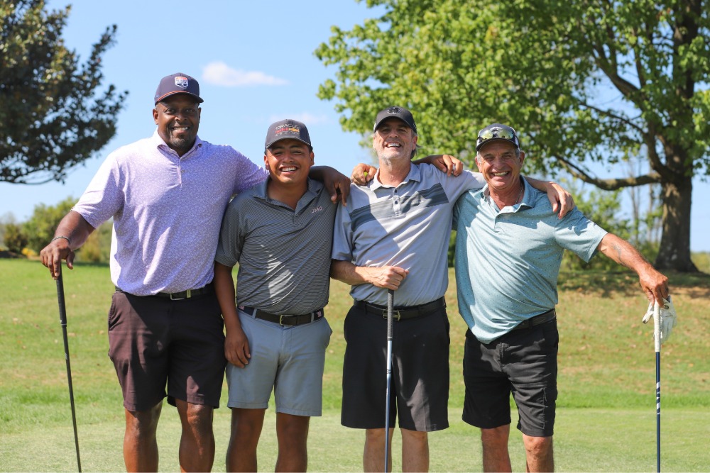 A group of golfers pose for the camera