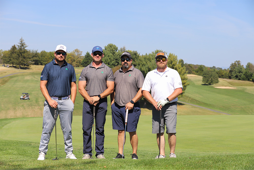 A group of golfers pose for the camera during the 2025 DCCU Cares Foundation charity golf tournament.