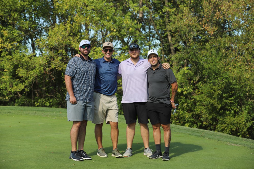 A group of golfers pose for the camera