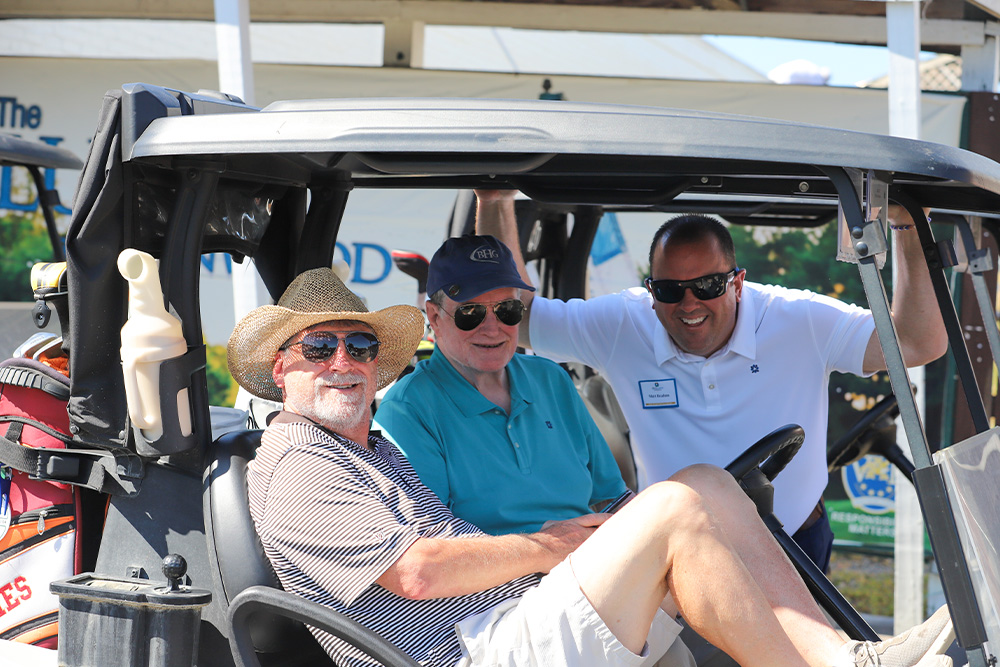A group of golfers pose for the camera during the 2025 DCCU Cares Foundation charity golf tournament.