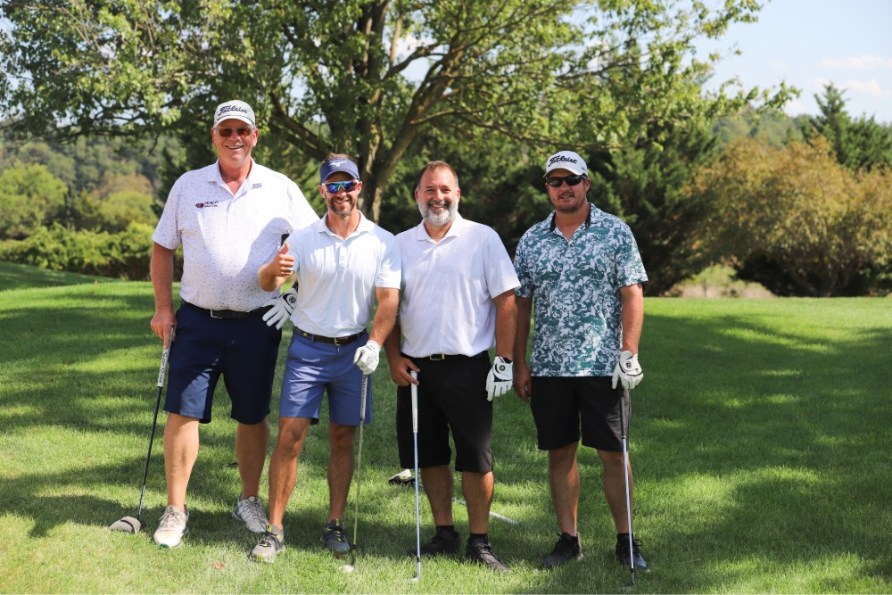 A group of golfers pose for the camera