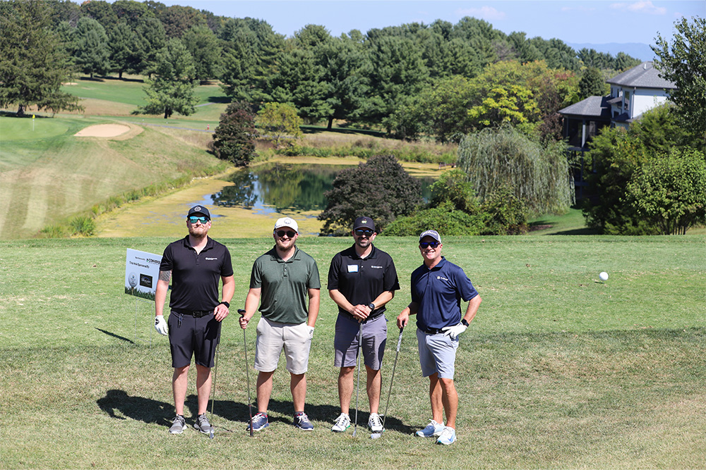 A group of golfers pose for the camera during the 2025 DCCU Cares Foundation charity golf tournament.