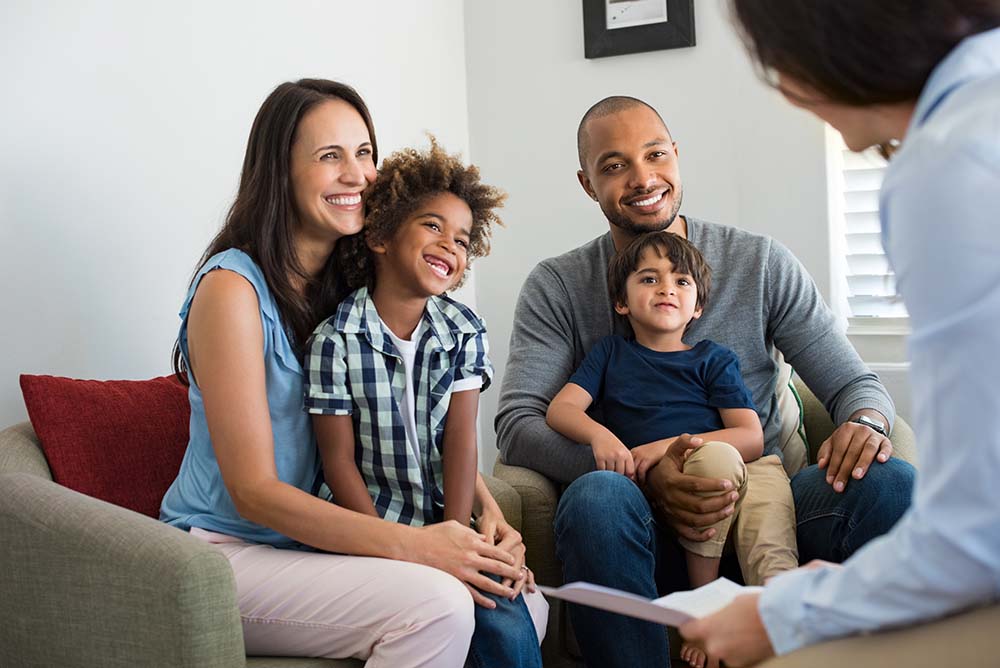 family of four meeting with advisor