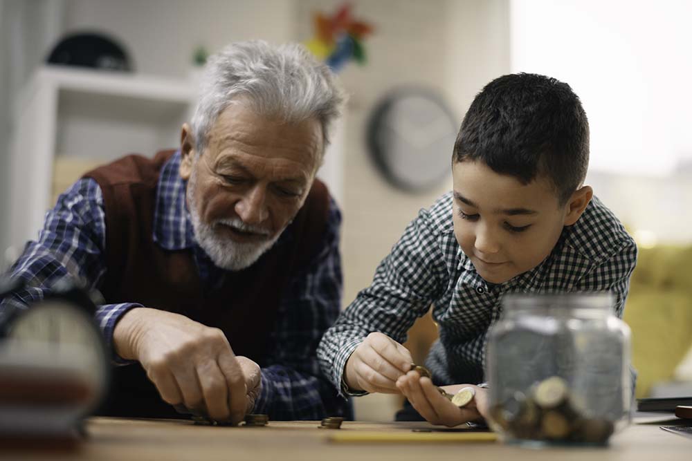 grandfather and grandson counting loose change together