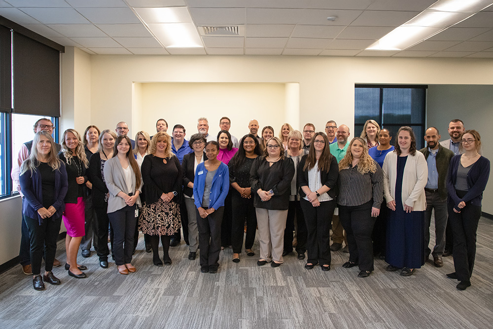 DCCU employees stand together as they are recognized for significant service milestones in 2025.