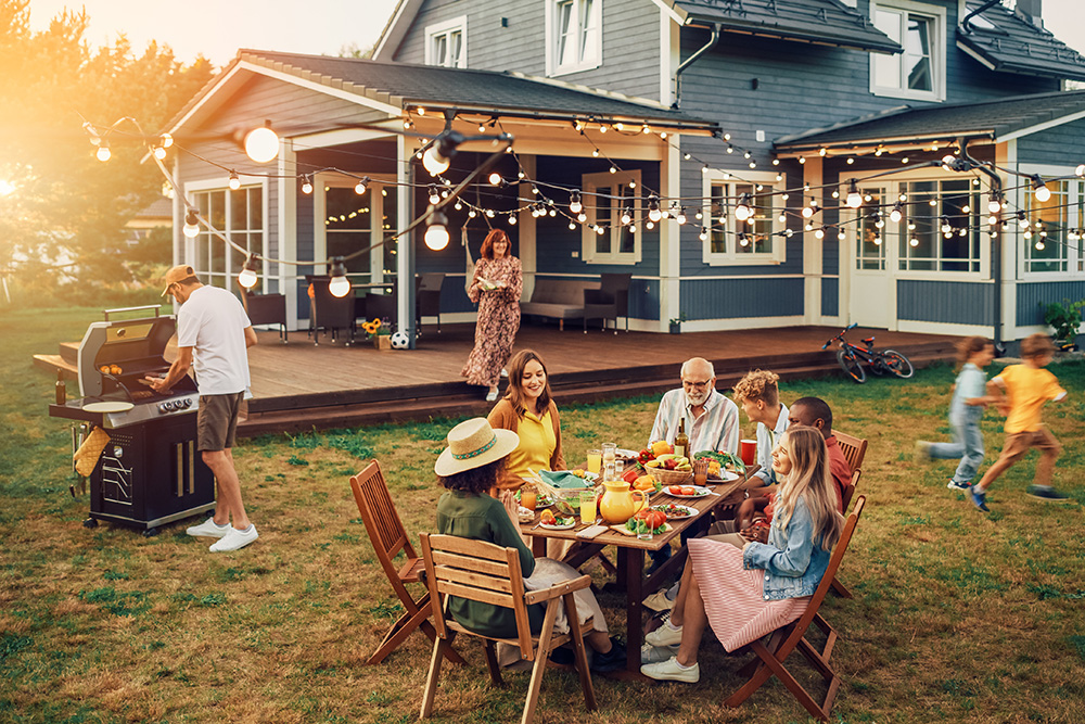 family hosting cookout in backyard