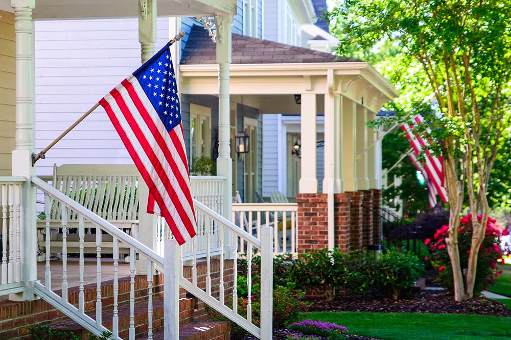 neighborhood with American flags on porches