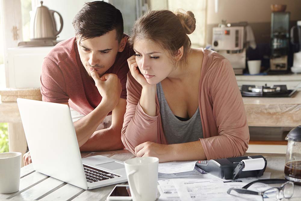 couple looking at computer concerned
