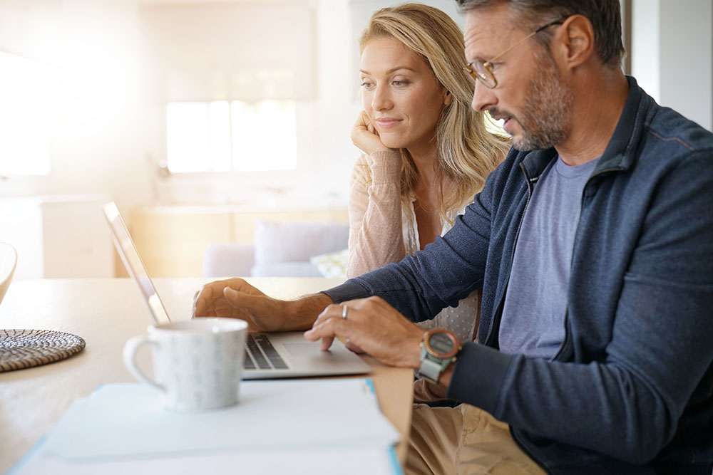 couple looking at computer together at table
