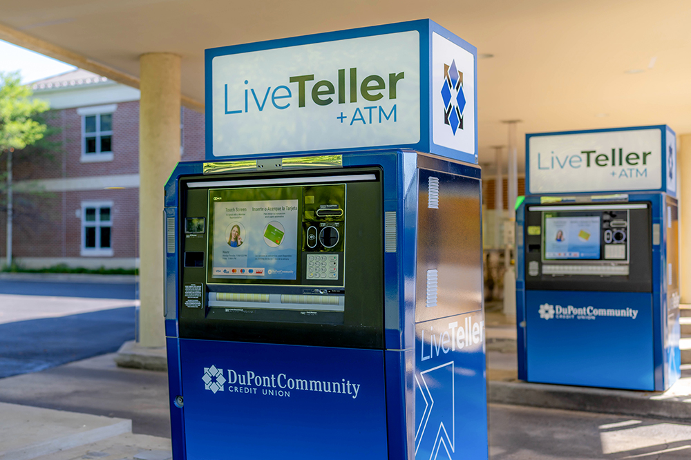 atm machine with the liveteller sign on top in a bank drive thru