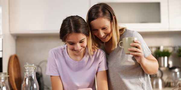 woman and young girl standing in a kitchen looking at counter