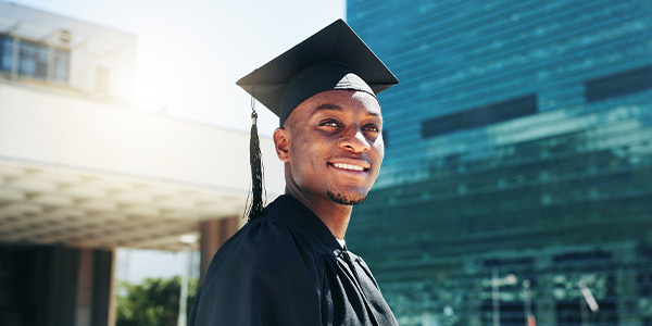 teen male in graduation cap and gown