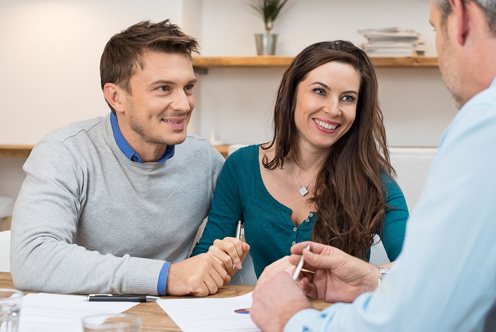 couple reviewing documents with financial advisor