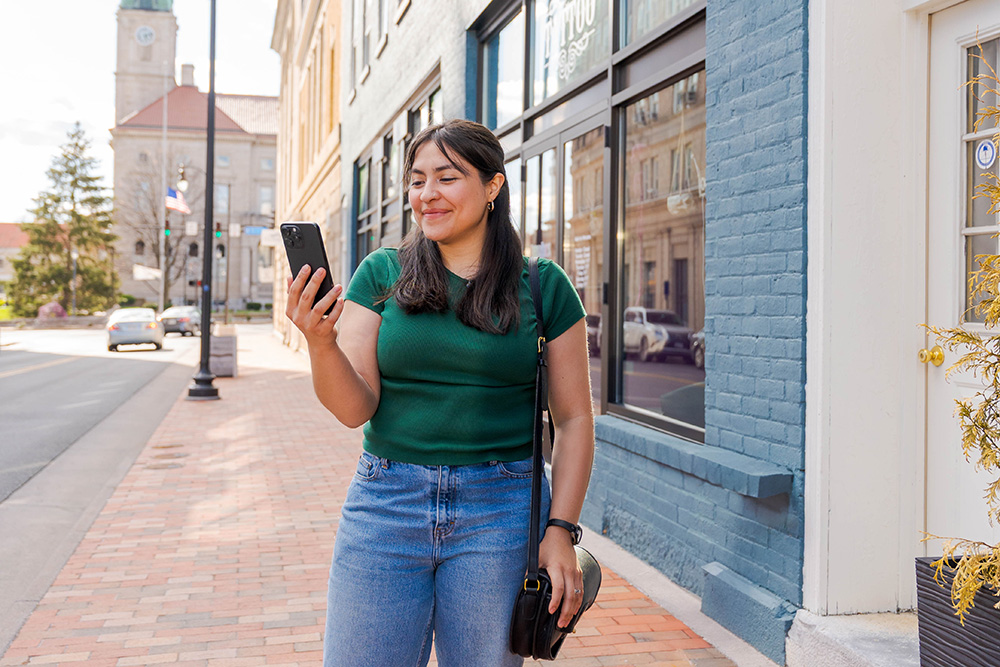 Woman looking at phone in downtown Harrisonburg, VA