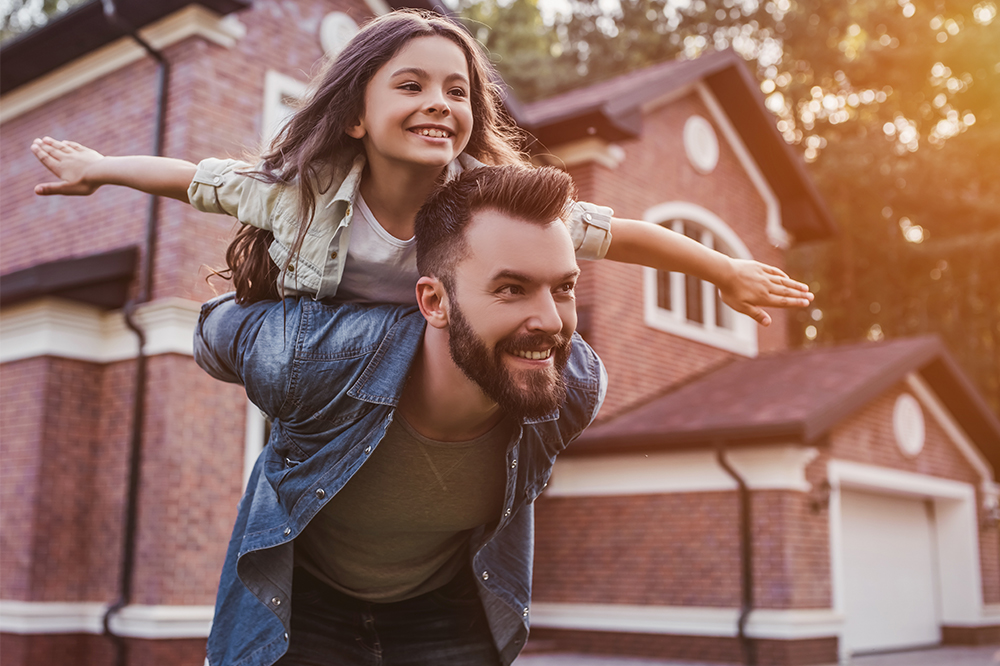 Dad and daughter playing together outside of home